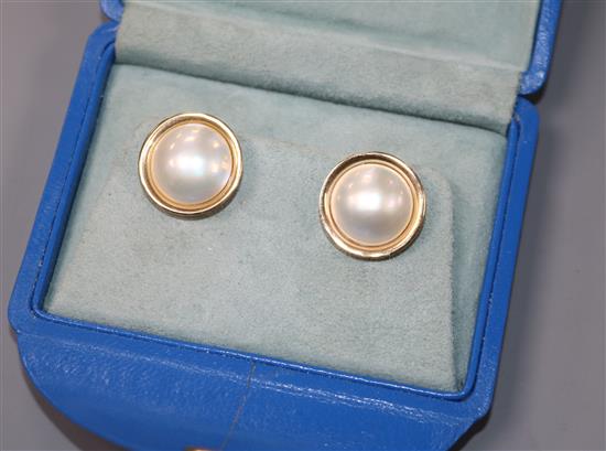 A pair of 9ct yellow gold and mabe pearl target earrings.